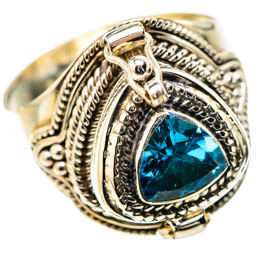 Ornate silver-tone ring with blue teardrop gemstone and raised rope-like border