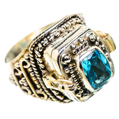 Sterling silver ring featuring a blue gemstone and engraved scrollwork side panels