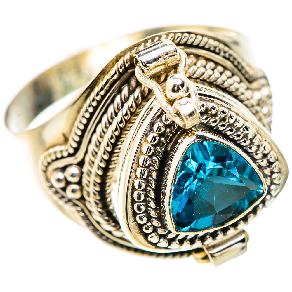 Ornate sterling silver ring with blue teardrop gemstone and engraved filigree