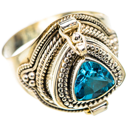 Ornate sterling silver ring with blue teardrop gemstone and engraved filigree