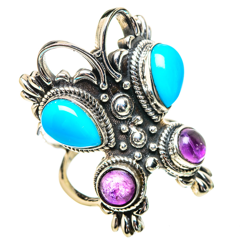 Silver ornate ring with turquoise teardrop and purple round cabochons, angled view