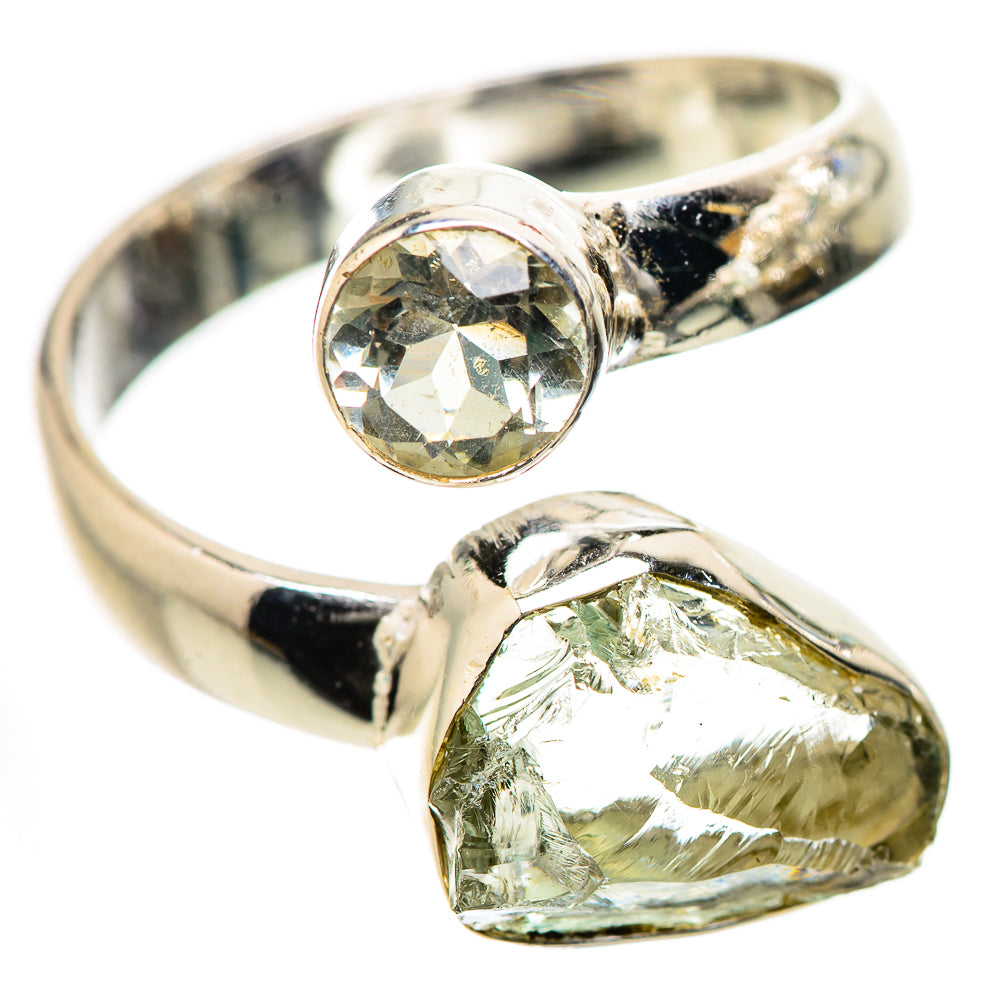 Sterling silver ring with clear round center stone and green teardrop gemstone, open band