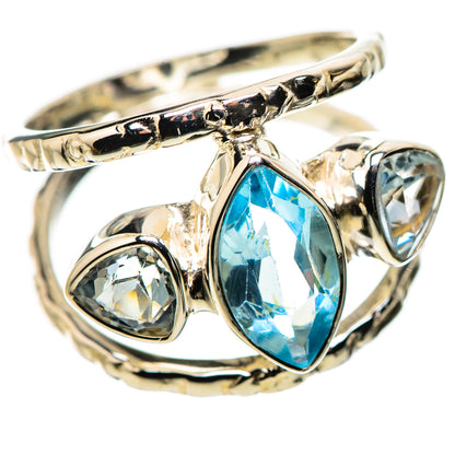 Sterling silver ring with blue oval topaz center and clear round side stones