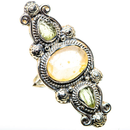 Sterling silver statement ring with ornate settings and oval green glass-like stones