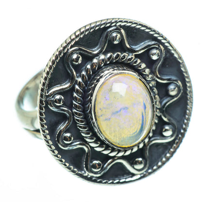 Sterling silver opal ring, oval cabochon with detailed filigree and rope border