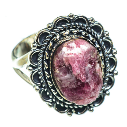 Sterling silver filigree ring with oval magenta-pink gemstone on antique setting