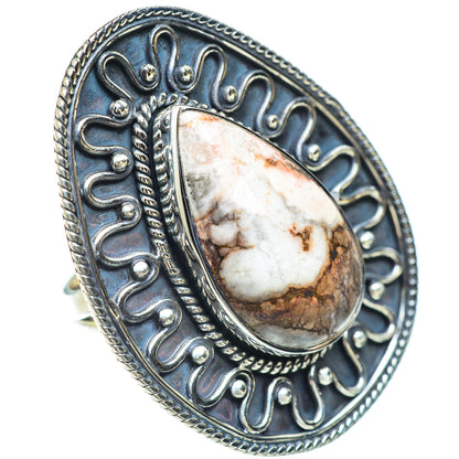 Sterling silver oval jasper ring on finger, detailed filigree bezel and border