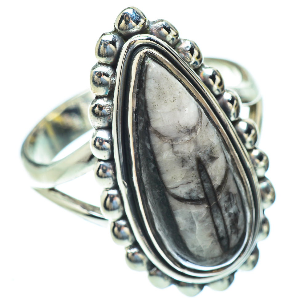 Sterling silver oval fossil ring with raised beadwork bezel and dark gray marbled stone