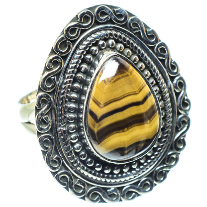 Sterling silver oval gemstone ring with tiger eye stripes and ornate raised bezel