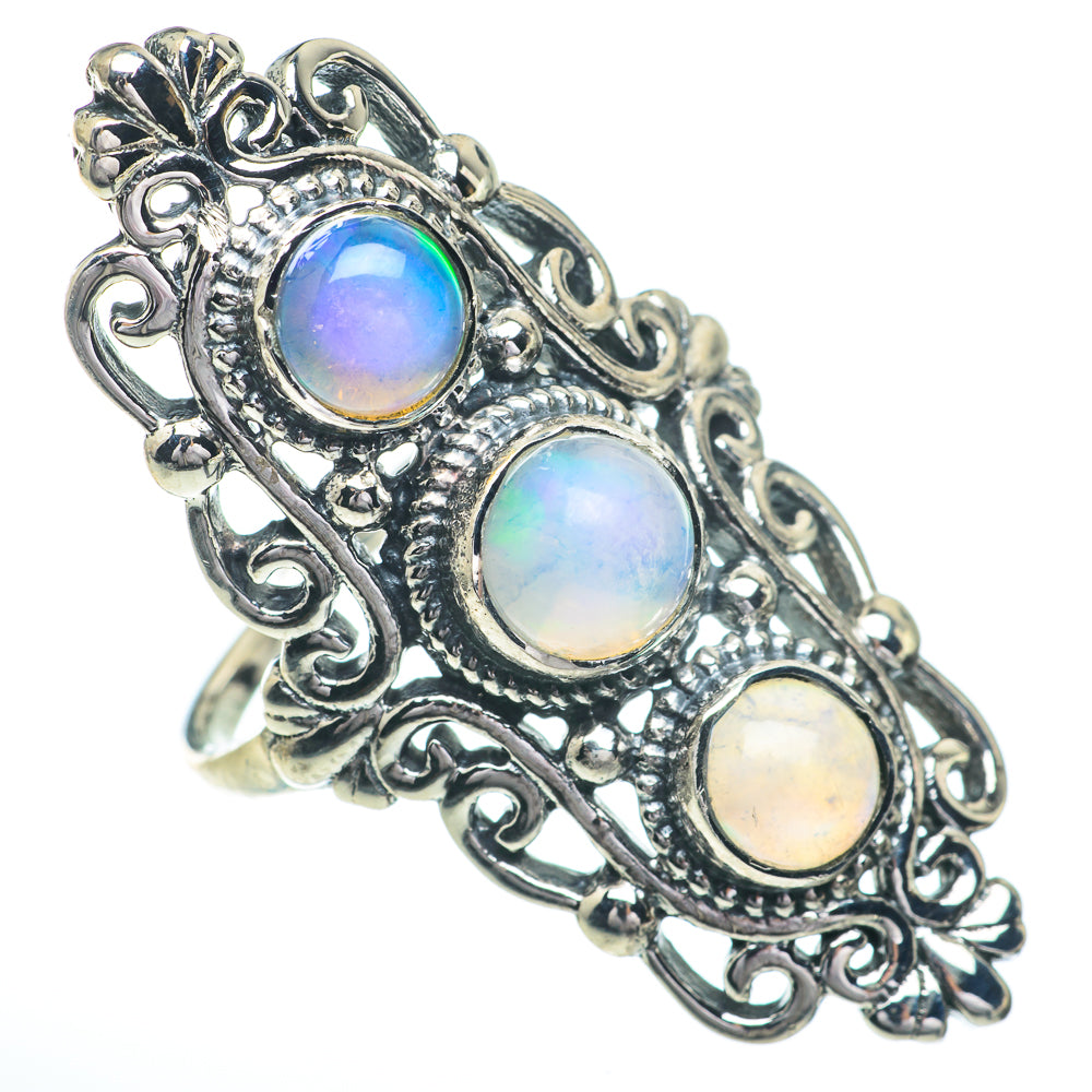 Sterling silver oval setting ring with three round opal-like stones, blue and cream iridescence.
