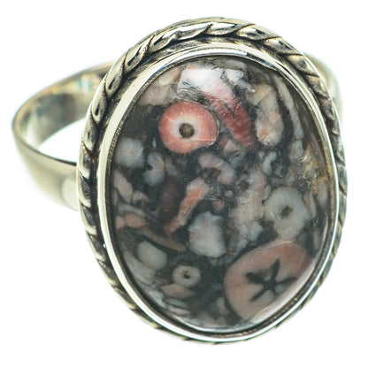 Sterling silver oval crinoid fossil ring with dark gray stone and red accents
