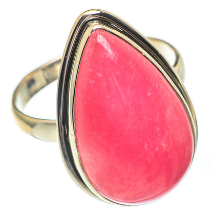 Large rhodochrosite ring with pink teardrop stone framed by polished sterling band