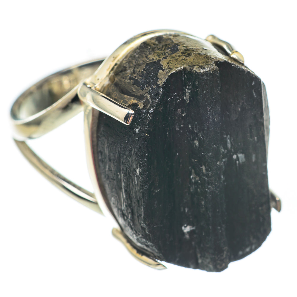 Rough black tourmaline ring with silver prongs, close-up on natural stone