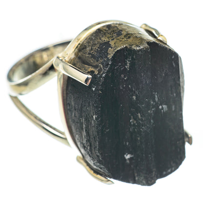 Rough black tourmaline ring with silver prongs, close-up on natural stone