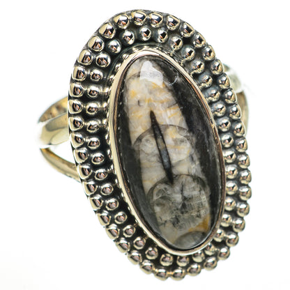 Sterling silver oval fossil ring with raised beaded bezel and oval cabochon stone