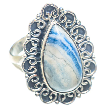 Sterling silver ring with blue teardrop gemstone and ornate openwork border