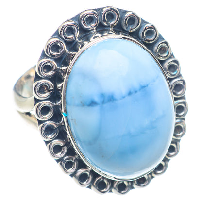 Sterling silver opal ring with oval light blue cabochon and raised bead borders