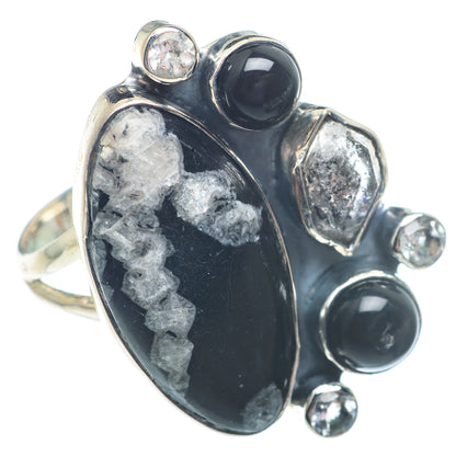 Sterling silver gemstone ring with large black oval cabochon and round black accents