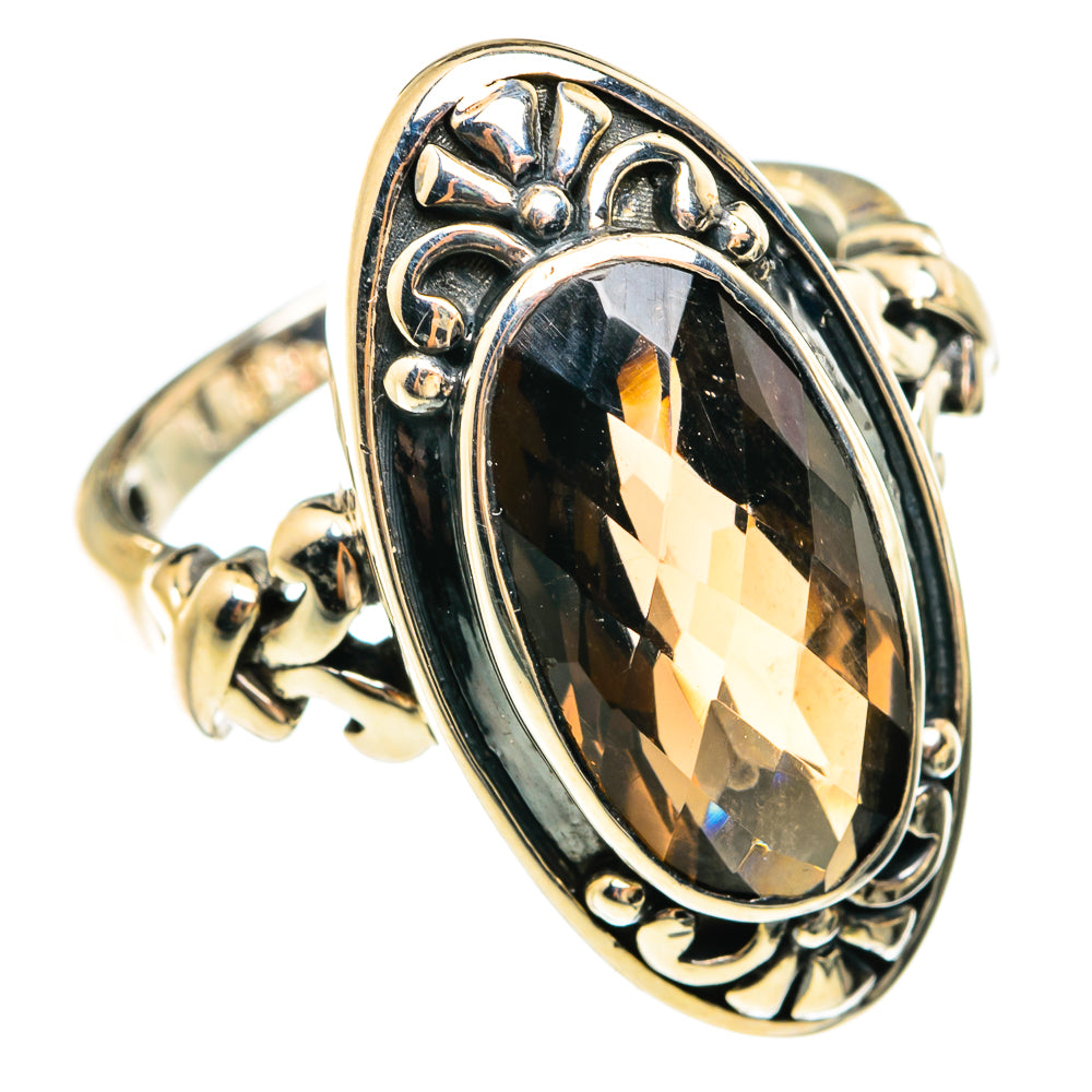 Smoky quartz oval ring with raised border and sculpted side details in sterling silver.