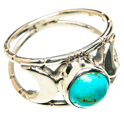 Sterling silver ring with turquoise oval cabochon, ornate raised bezel and split shank.