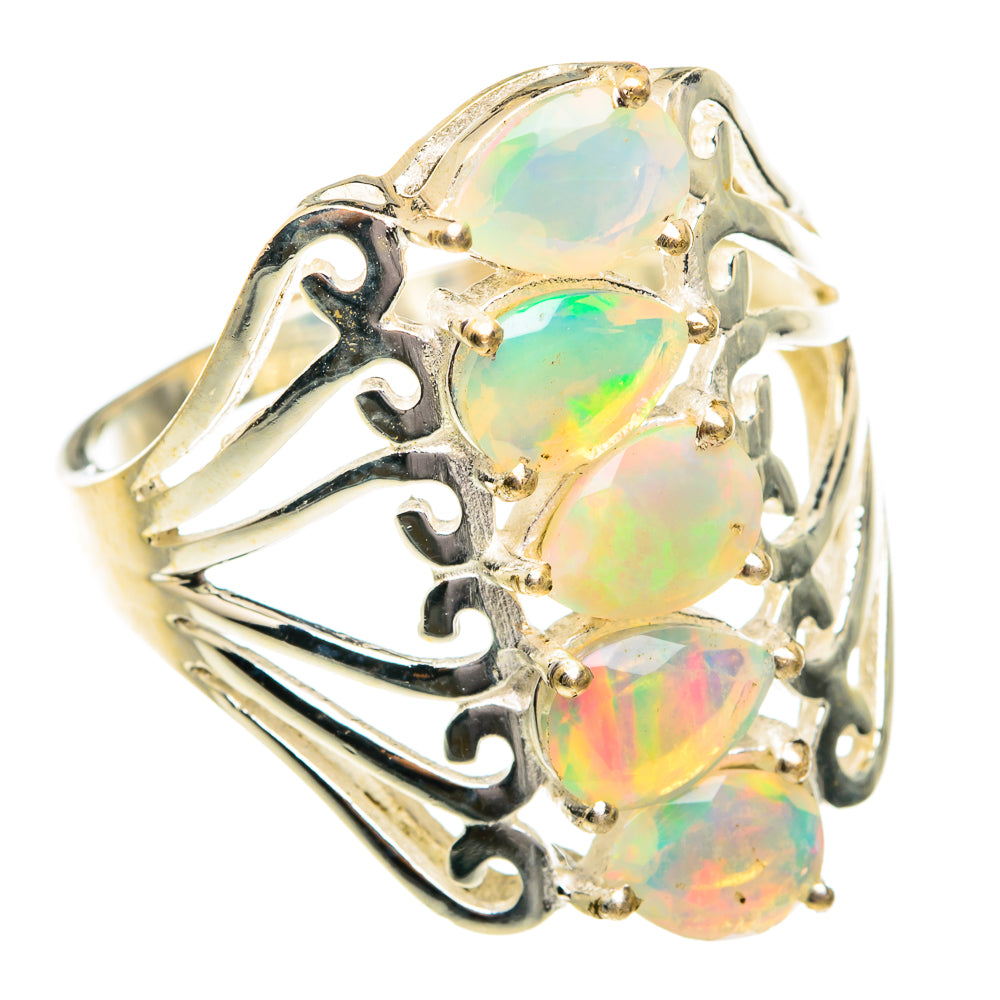 Opal statement ring with three oval faceted stones in ornate openwork setting
