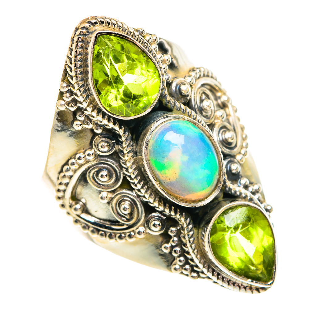 Sterling silver filigree ring with oval opal center and green peridot side stones