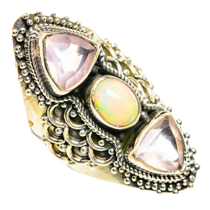 Ornate sterling silver ring with oval opal and two pink faceted teardrop gemstones