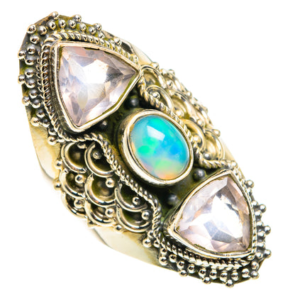 Ornate sterling silver ring with two triangle stones and blue-green oval opal