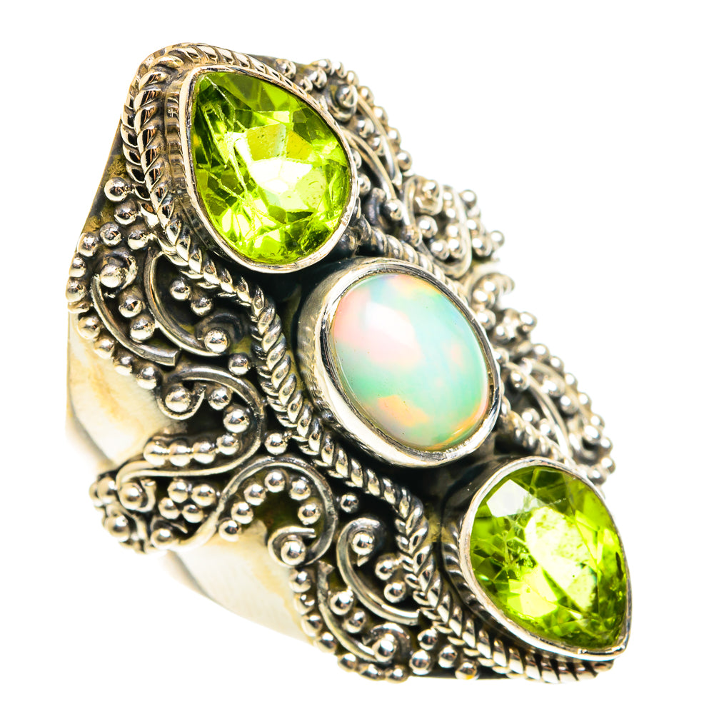 Silver ornate ring with green teardrop peridot stones and round opal.