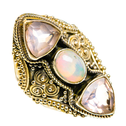 Ornate gold-tone statement ring with three bezel-set gemstones, teardrop and round shapes