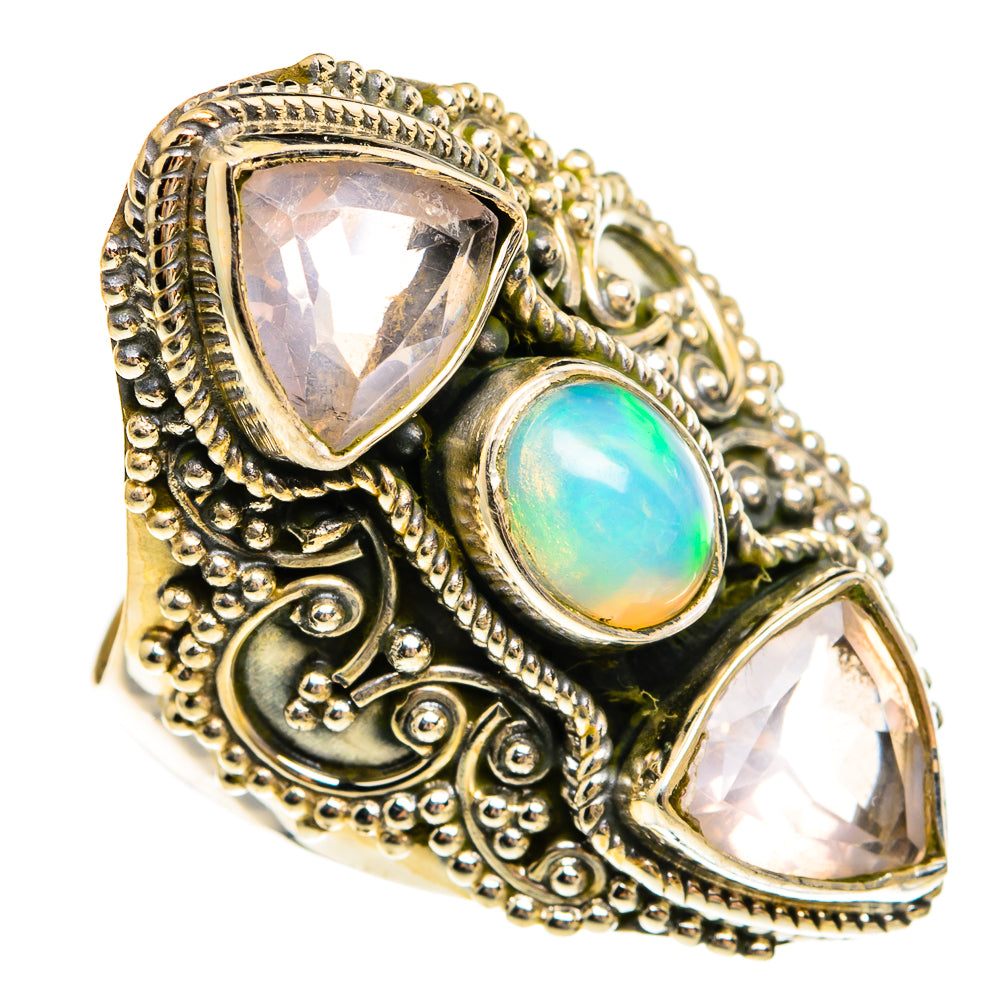 Ornate silver ring with oval blue-green opal center and two faceted triangular stones
