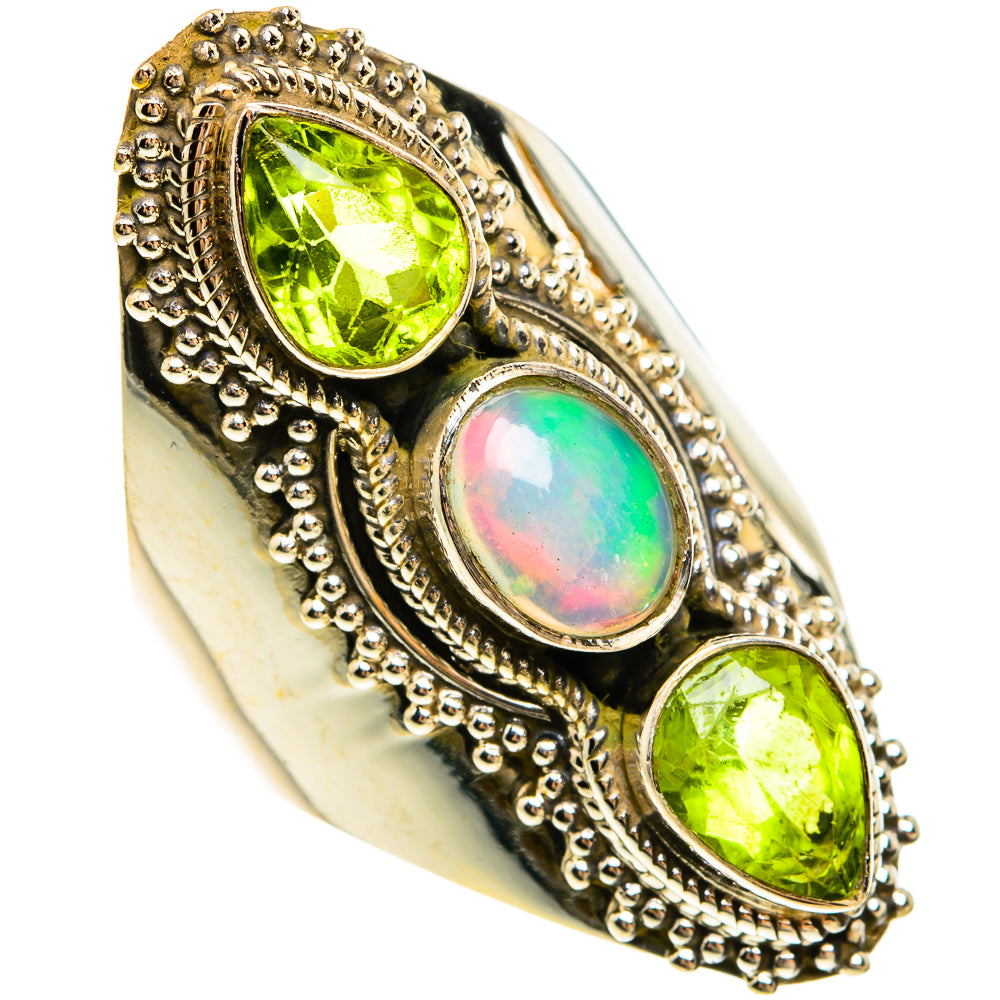 Silver ring with bezel-set green peridot stones and an iridescent opal center