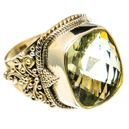 Sterling silver oval ring with large faceted green gemstone and detailed braided setting