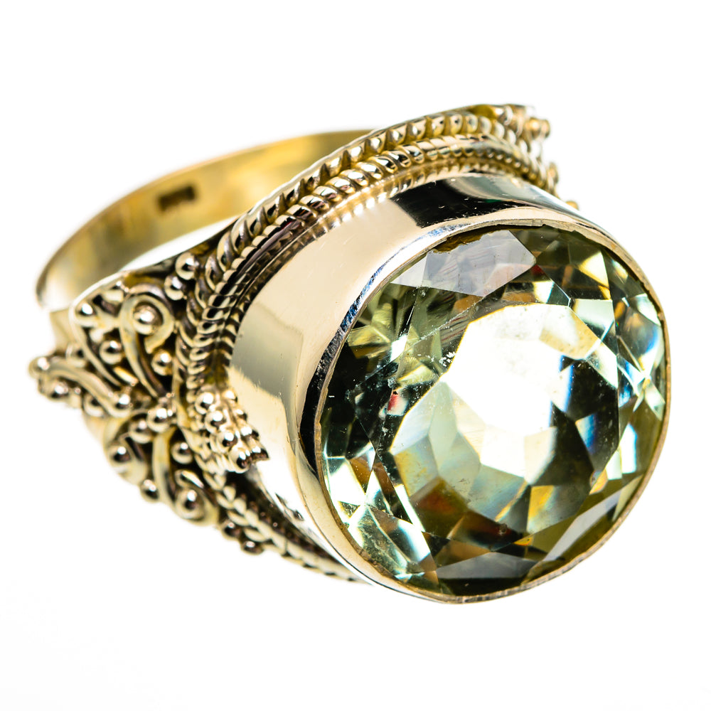 Green faceted gemstone ring, round bezel setting with decorative metalwork along band