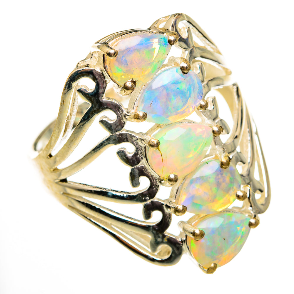 Gold-tone opal ring with three oval iridescent stones and openwork side detail