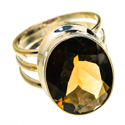Smoky quartz ring with large oval faceted gemstone in polished metal bezel and band