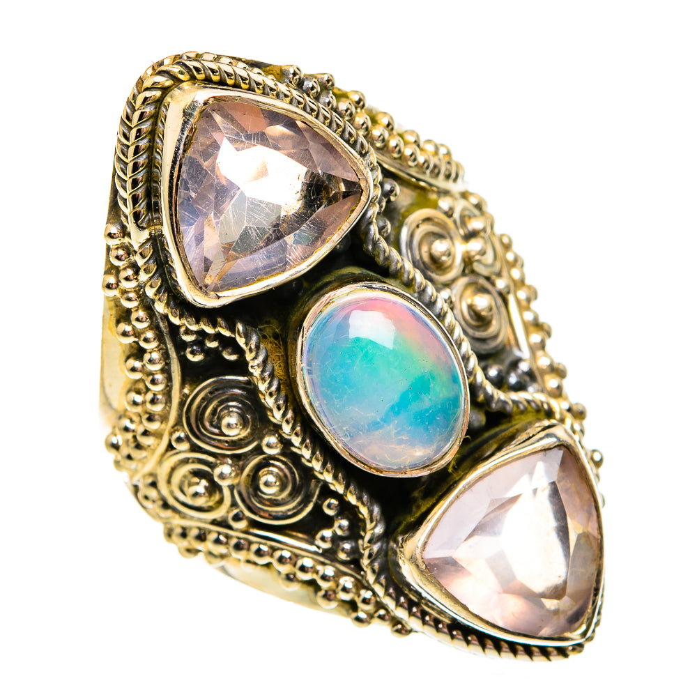 Antique gold-tone filigree ring with center blue opal and two pale pink teardrop stones