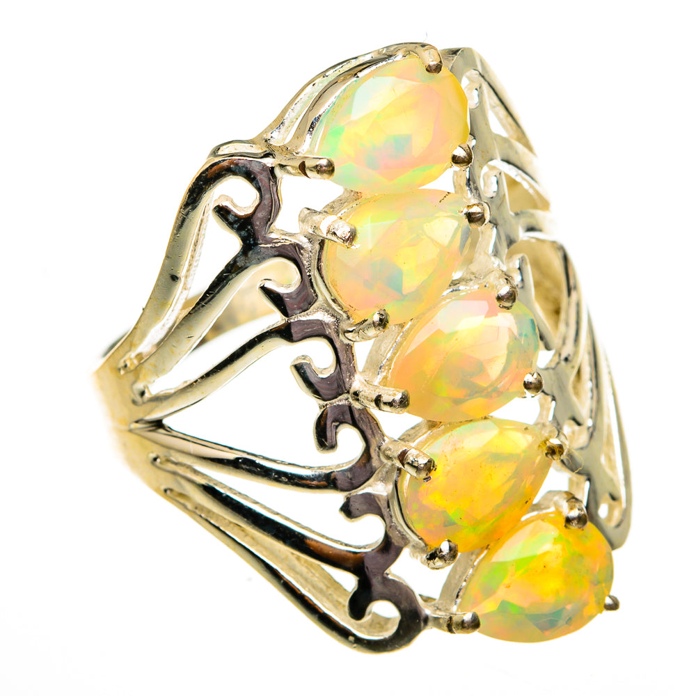 Gold-tone opal ring with three oval faceted opals, prong-set, with decorative scrollwork
