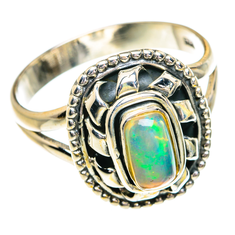 Sterling silver opal ring with oval green-blue opalescent center and scalloped frame