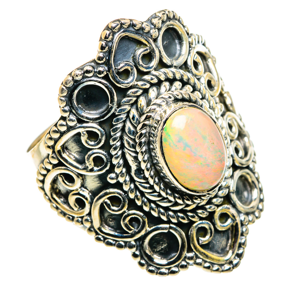 Sterling silver opal ring with round iridescent cabochon and ornate filigree setting