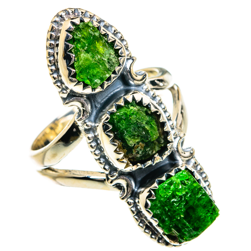 Silver ring with rough green gemstone cluster; shield-like bezels and scalloped edges