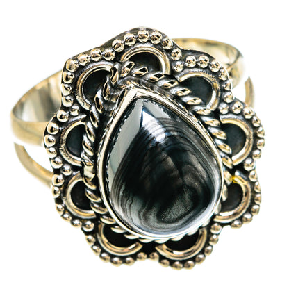 Sterling silver ring with oval dark gray cabochon and beaded filigree border on band