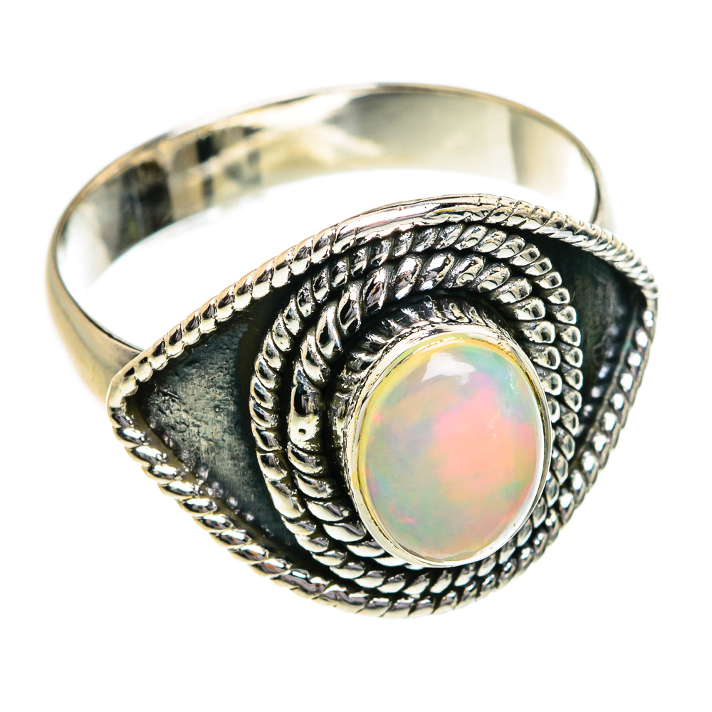 Sterling silver opal ring with oval opal centerpiece and braided patterned bezel, size 7.25