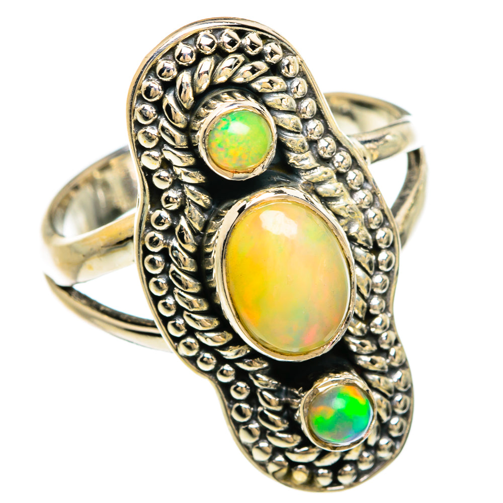 Sterling silver opal ring with oval center and round green opals, ornate setting