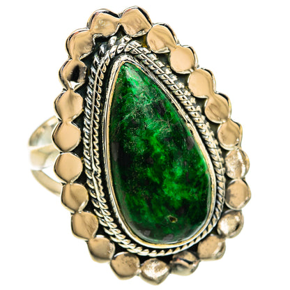Sterling silver ring with large green oval stone and ornate scalloped border