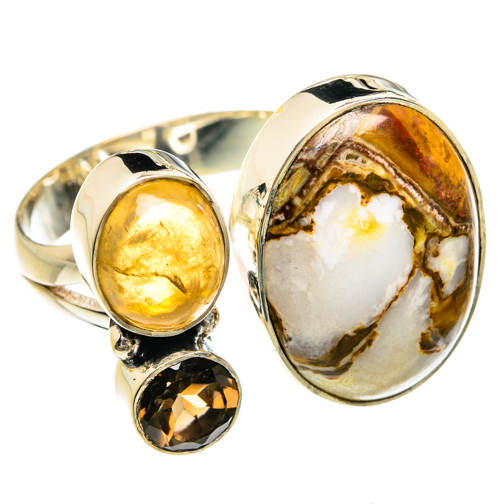 Oval gemstone ring with sterling silver prongs, white-and-amber center, yellow and dark stones