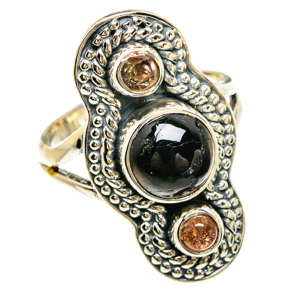 Sterling silver ring with dark oval onyx and two round pink stone accents