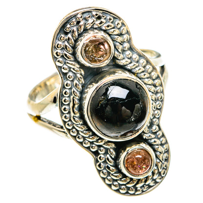 Sterling silver ring with dark oval onyx and two round pink stone accents