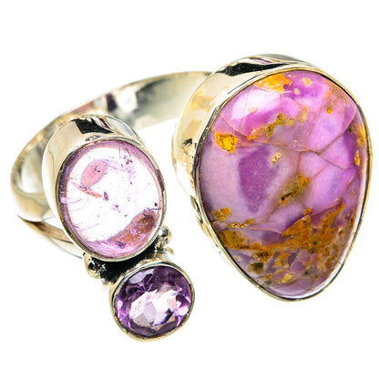 Silver-toned ring with oval purple cabochon and round purple gemstone accents