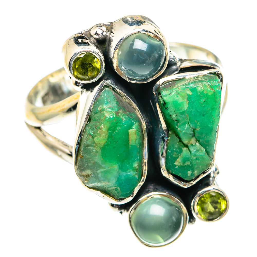 Silver ring with light blue oval, rough green stones, and small round green gems